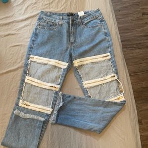 Light blue jeans with rips and zippers